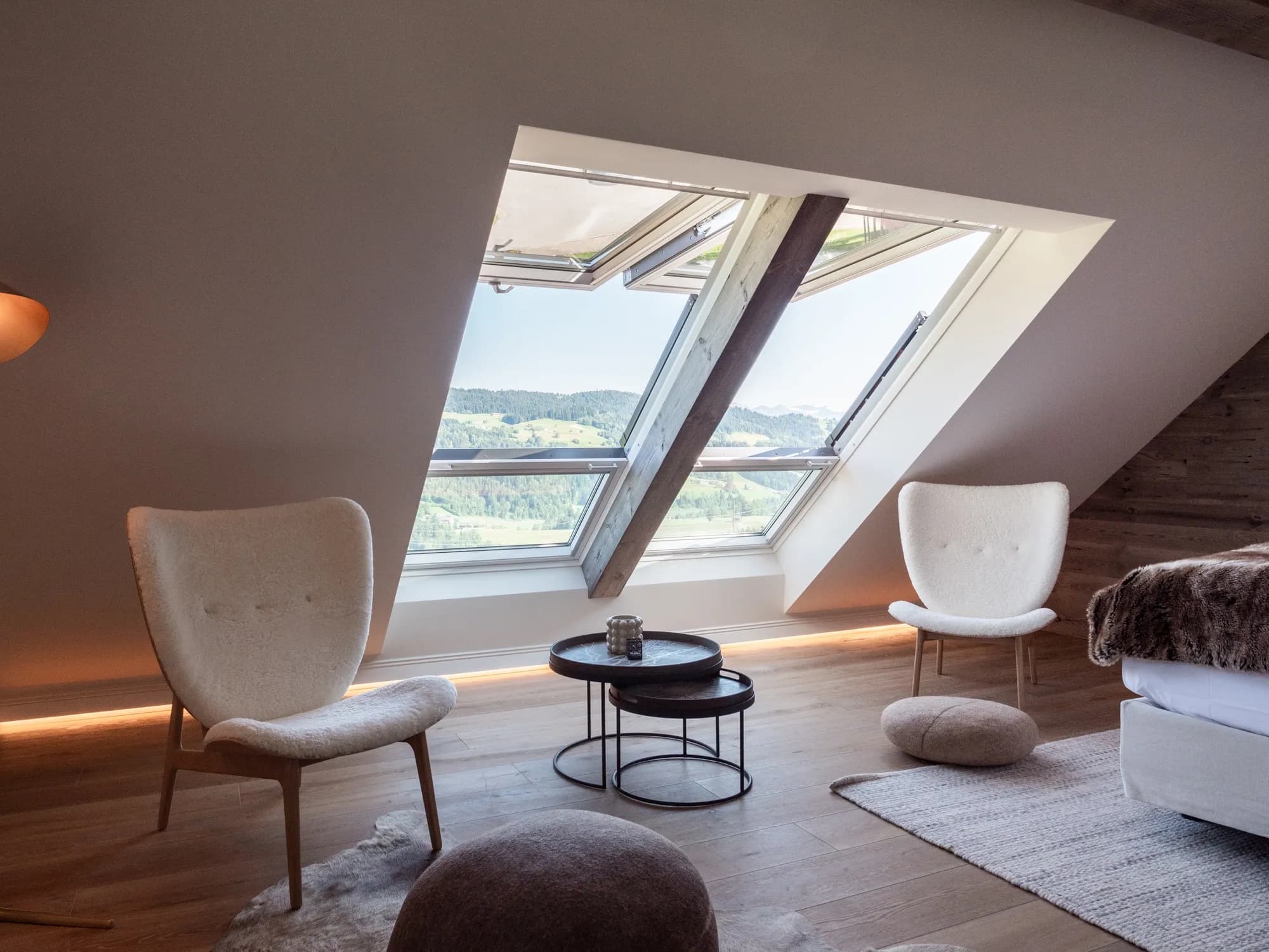 Sitzecke der Suite Neun unterm Dachfenster, zwei Sessel und ein niedriger Tisch