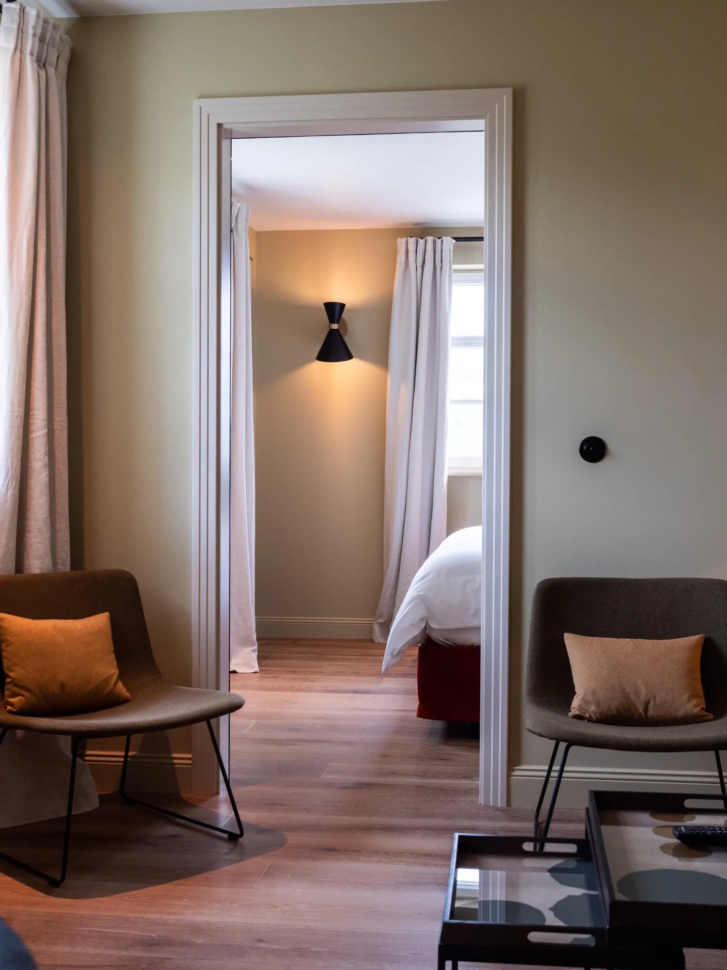 Blick vom Sitzbereich durch die Tür ins Schlafzimmer der Suite Sechs